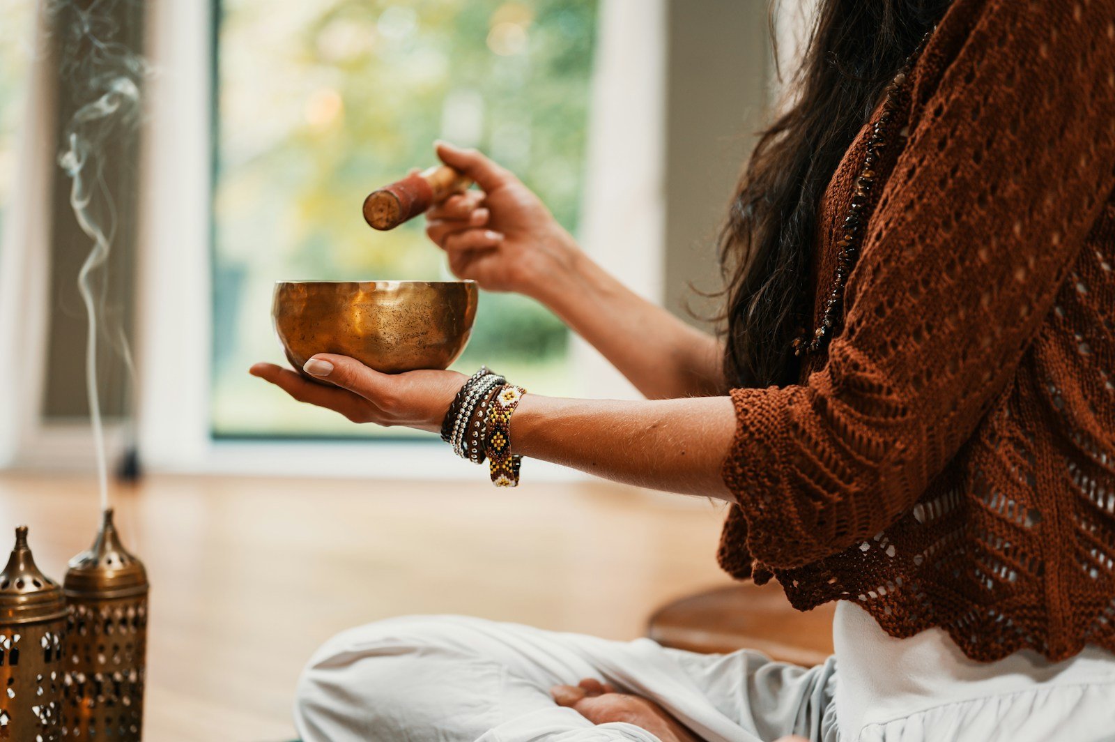 woman in brown knit sweater holding brown ceramic cup, relaxation