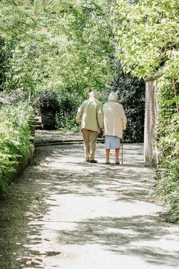 man and woman walking on road during daytime, autonomie, seniors, bien-être, prevention des chutes